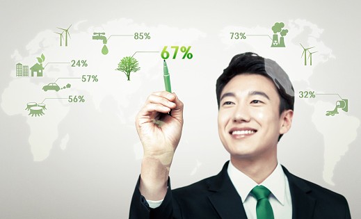 a businessman clicking at world map with green energy